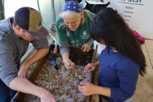 Frankie Snyder explains finds to volunteers during sifting at the Temple Mount Sifting Project